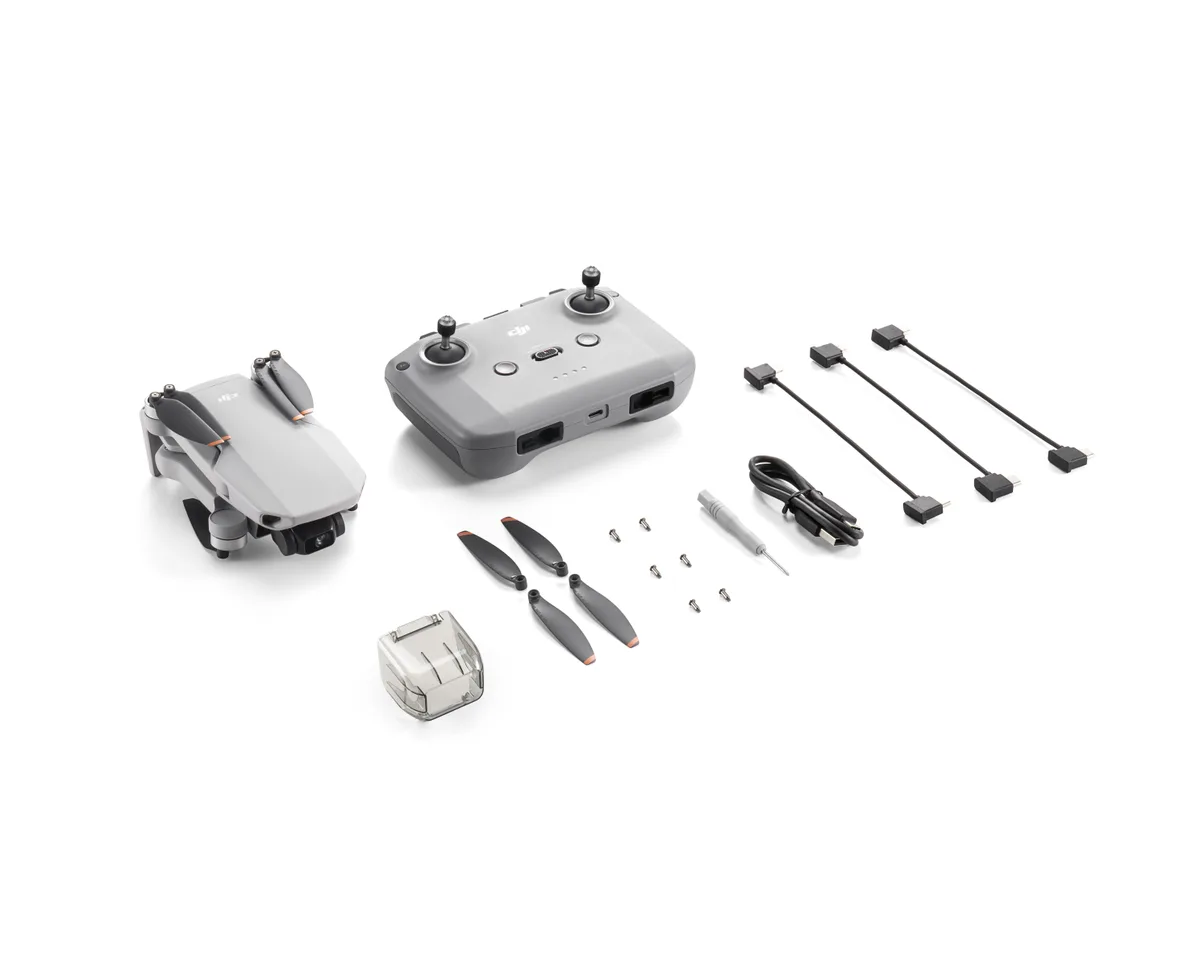 DJI Mini 2 SE drone, remote controller and box contents laid out