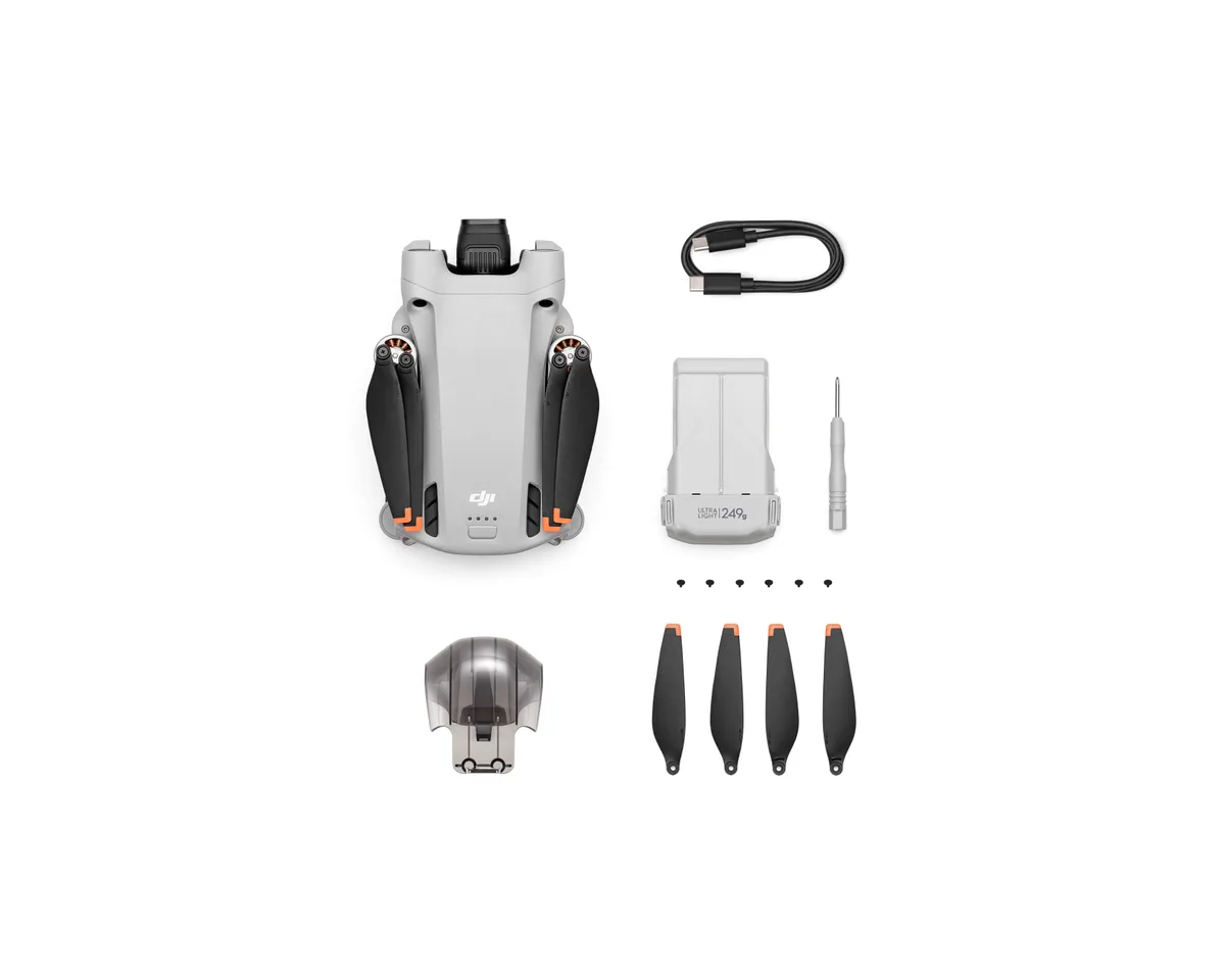 DJI Mini 3 Pro drone, folded, with its battery, propellers and cable laid out