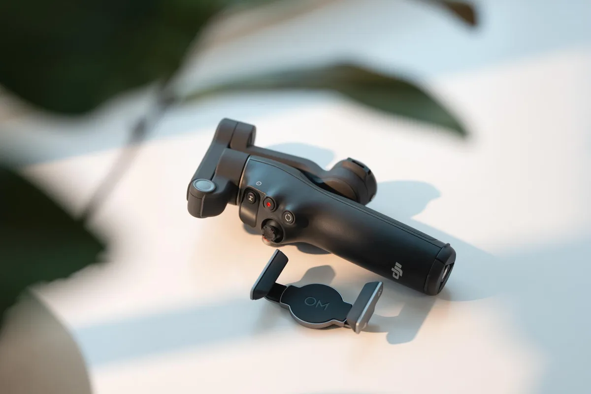 DJI Osmo Mobile 8 smartphone gimbal lying folded on a table